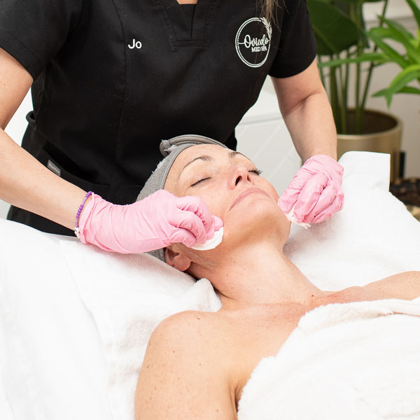 woman receiving facial treatment