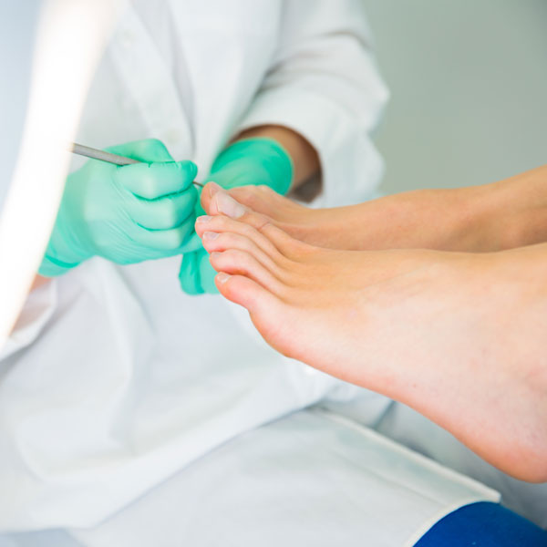 doctor examining patient's toes