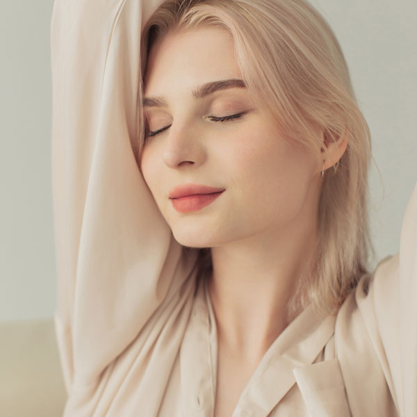 woman relaxing with arms raised