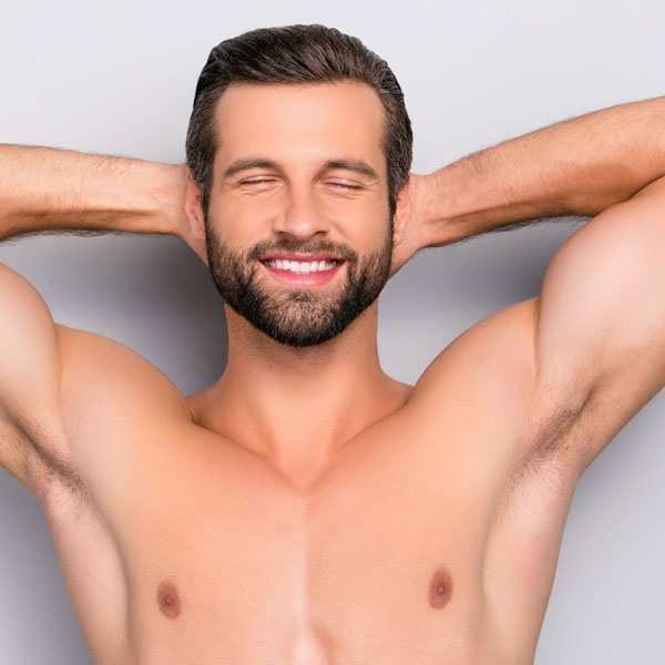 shirtless muscular man with arms behind his head relaxing