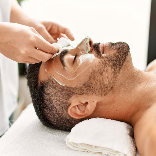 man receiving facial treatment