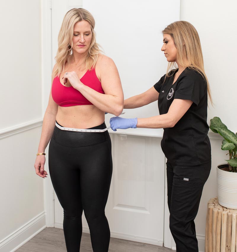 Woman measuring her waist after semaglutide