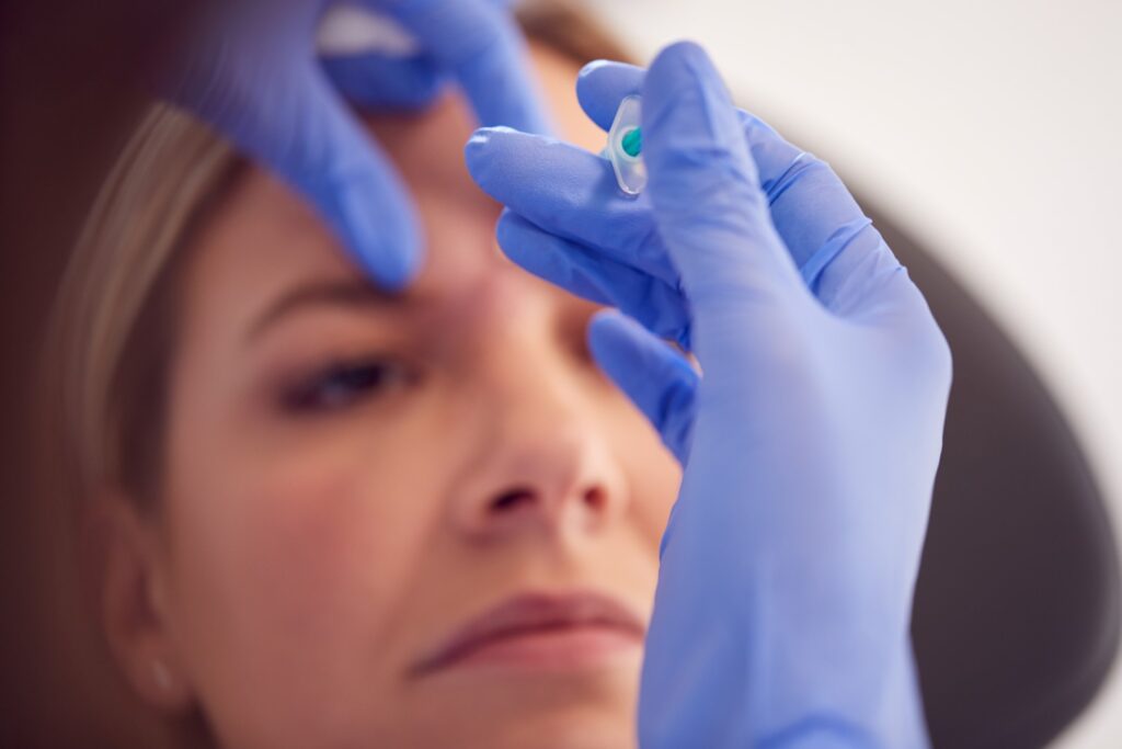 Woman Sitting In Chair Being Given Botox Injection 