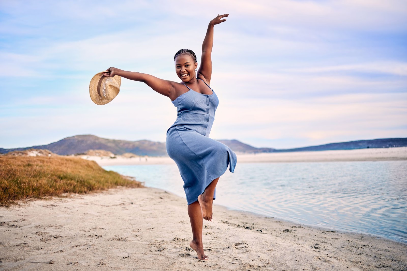 woman dancing next to lake