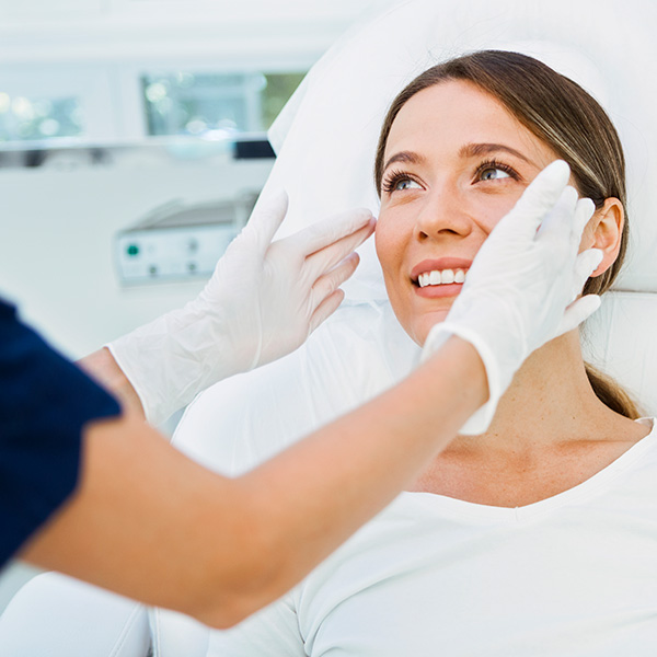 a woman getting a facial treatment