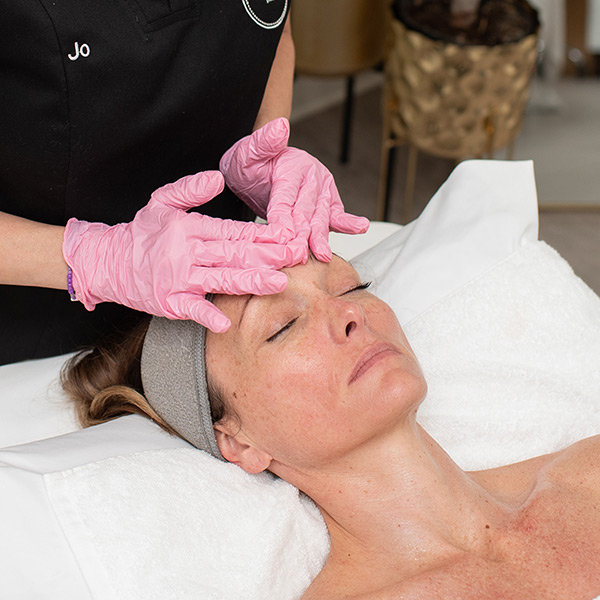 a woman getting a facial treatment